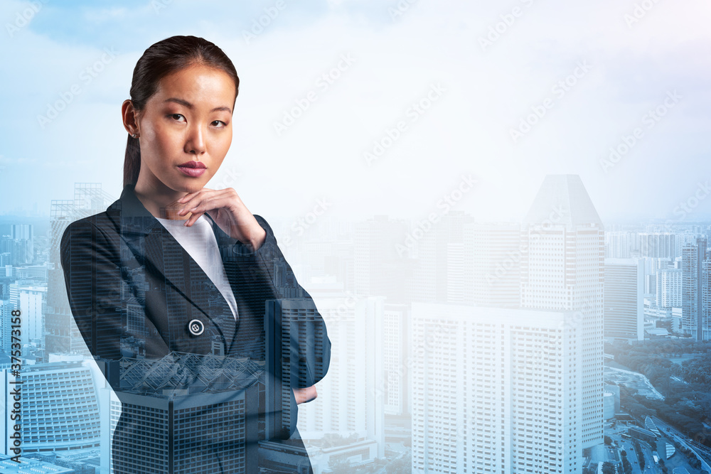 Attractive young Asian business woman in suit with hand on chin thinking how to succeed, new career opportunities, MBA. Singapore on background. Double exposure. Attractive young Asian business woman in suit with hand on chin thinking how to succeed, new career opportunities, MBA. Singapore on background. Double exposure.