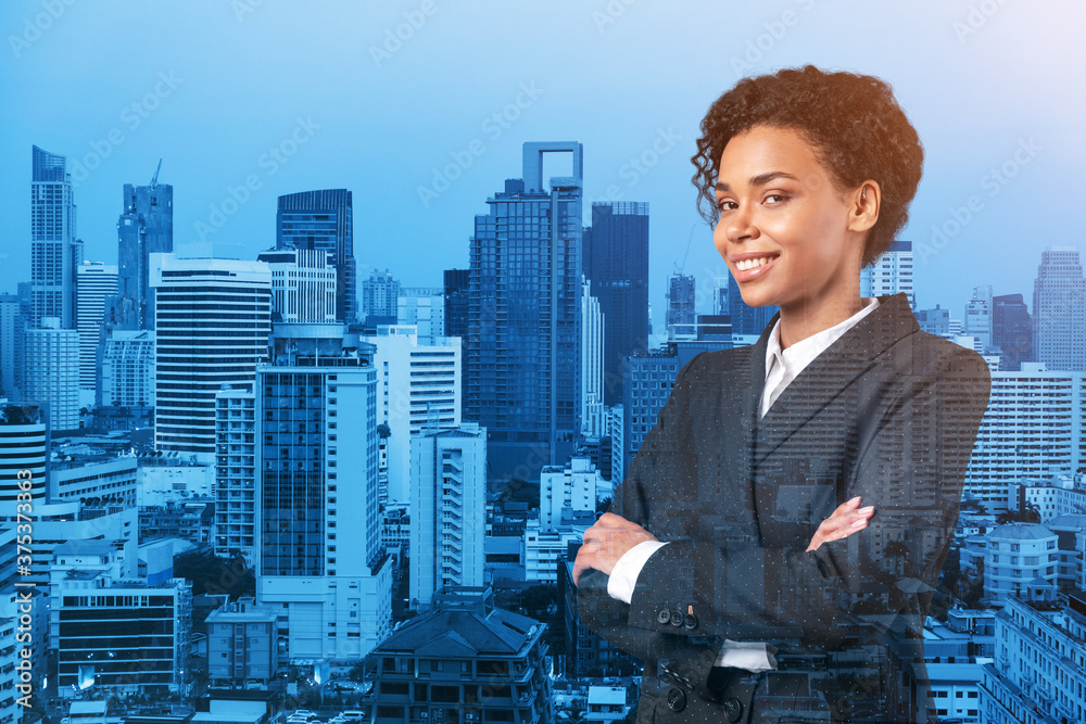 Smiling black African American business woman in suit in crossed arms pose. Bangkok cityscape. The concept of woman in business. Investment fund. Double exposure. Smiling black African American business woman in suit in crossed arms pose. Bangkok cityscape. The concept of woman in business. Investment fund. Double exposure.