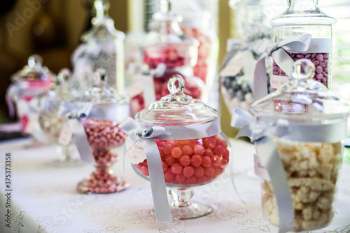 brightly colored candy in jars on table for event