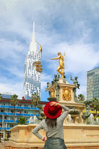 Fashionable Woman in Red Hat Impressed by the Gorgeous Neptune Fountain on Theater Square in Batumi, Georgia