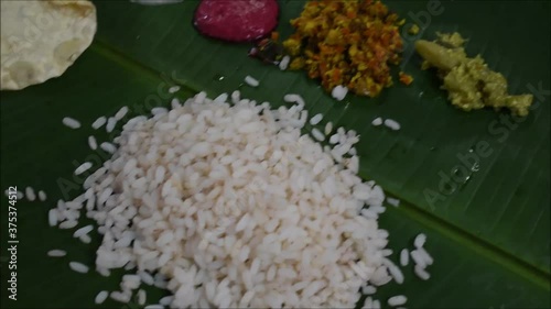 Video of pouring Parippu, south indian dish to traditional Onam Sadhya. photo