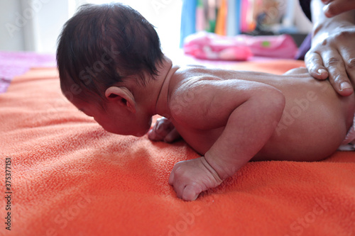 head holding exercise posture of a infant baby during tummy time photo