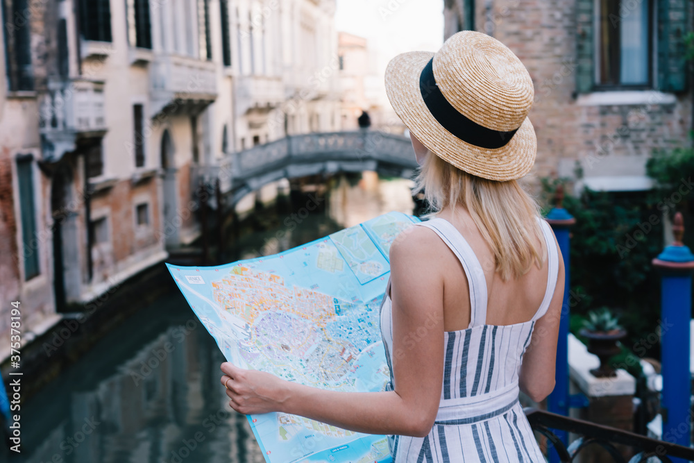 Young woman using map during journey