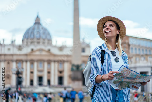 Canvas Print Smiling female tourist in straw hat enjoying beautiful architecture in Vatican f