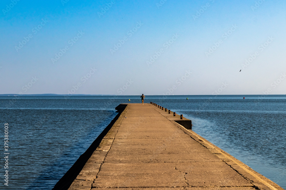 Fototapeta premium A women in Frombork pier, northern Poland