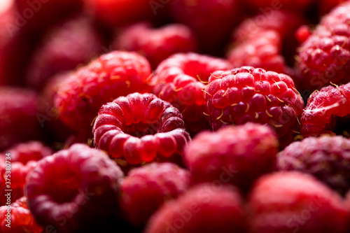 Fresh and sweet red raspberries texture. fruit pile background