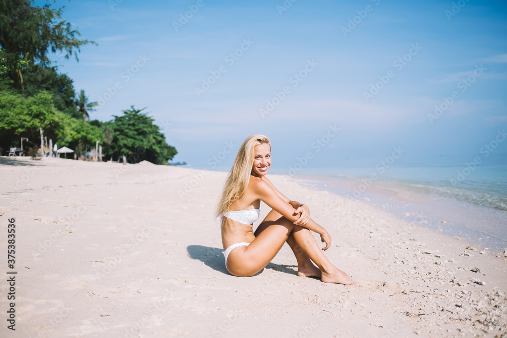 Female resting and sunbathing on sea coast