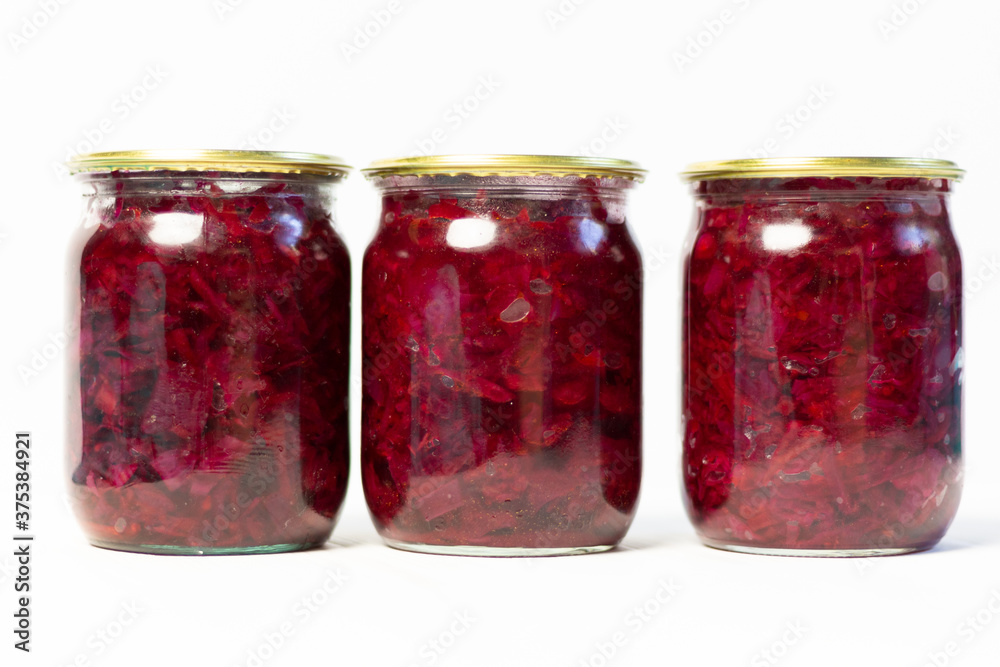 Canned Ingredients for borscht in glass jar as preserves on white background Canned Ingredients for borscht in glass jar as preserves on white background