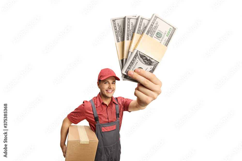 Delivery man holding a cardboard box and stacks of money Delivery man holding a cardboard box and stacks of money