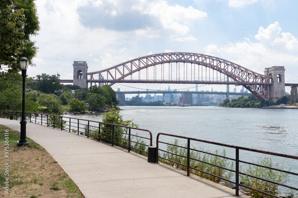Astoria Queens Riverfront Trail at a Park along the East River in New York City during Summer with the Hell Gate Bridge