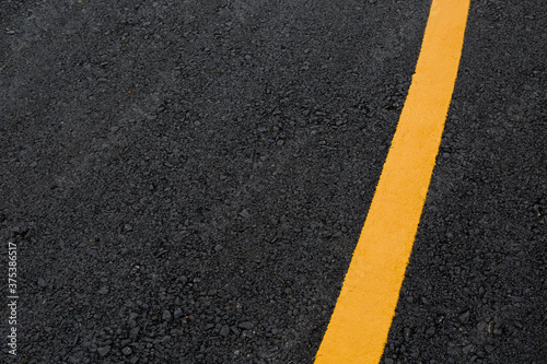 asphalt road with yellow lines © PARINYA