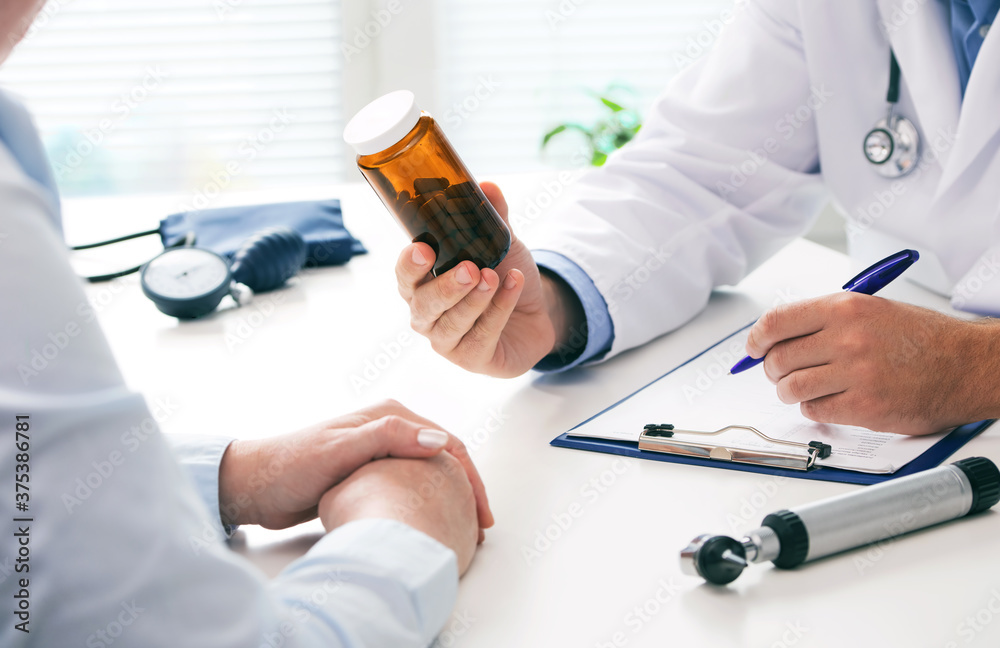 Doctor prescribing medicine to a patient in the office Doctor prescribing medicine to a patient in the office