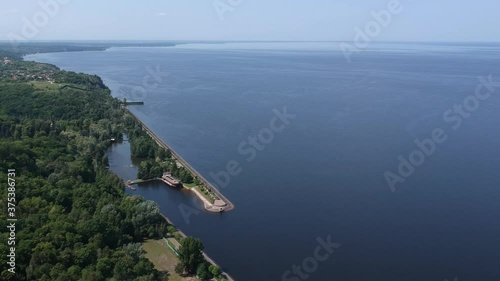 Aerial view. A large exotic wooden ship is located near the shore. Green lagoon. Kiev, Mezhyhirya. Drone