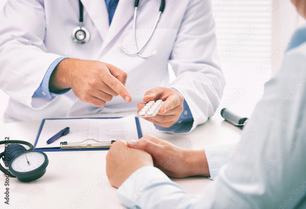 Doctor prescribing medicine to a patient in the office Doctor prescribing medicine to a patient in the office
