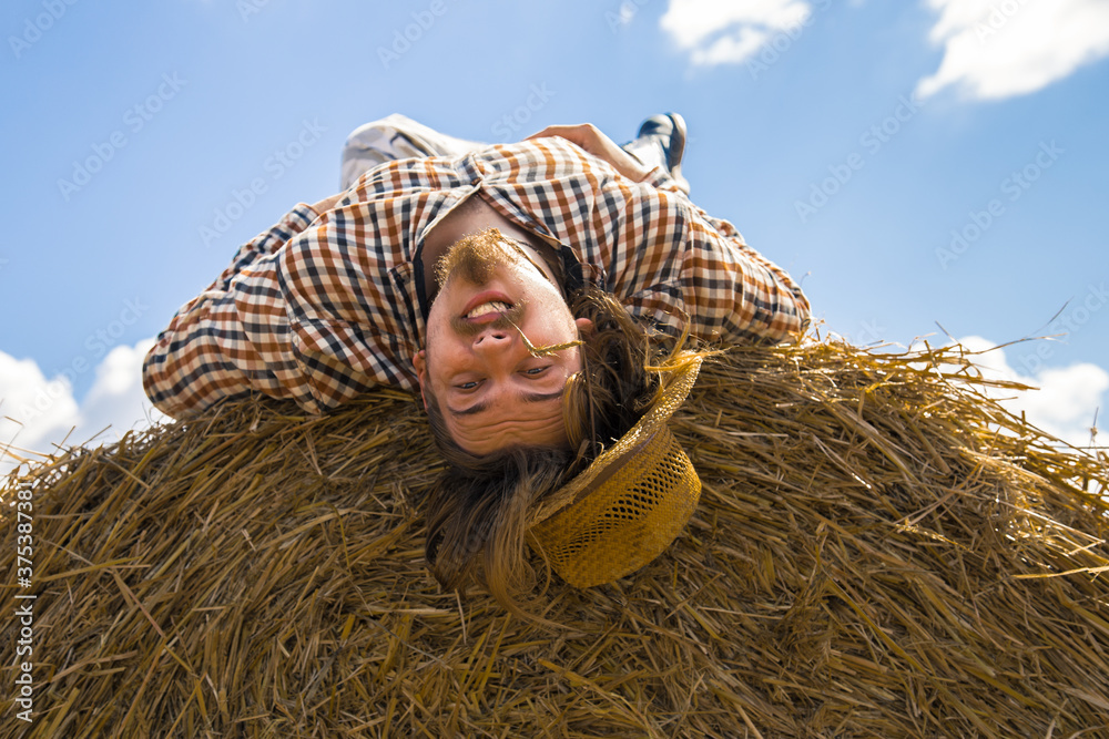 A young bearded man in cowboy hat with wheat roll A young bearded man in cowboy hat with wheat roll