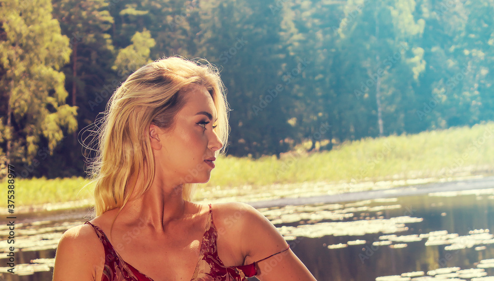 Beautiful young blonde woman portrait in nature up close Beautiful young blonde woman portrait in nature up close