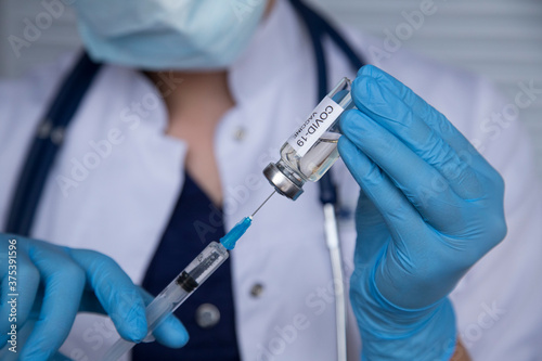 Doctor's Hand holding syringe and vaccine for vaccination in the hospital