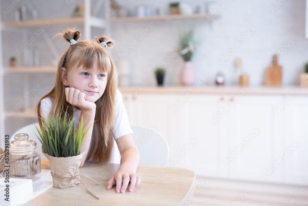 Obraz premium concept of children in the kitchen. Adorable little girl in a white T-shirt.