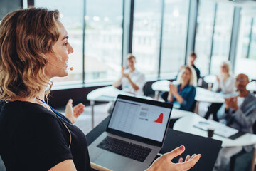 Businesswoman addressing to group of professionals