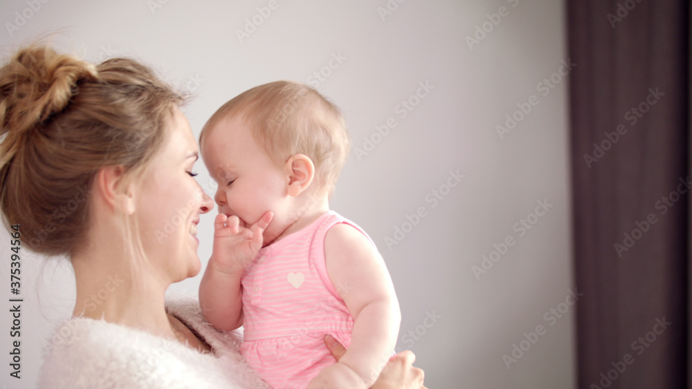 Sweet mother with little baby on hands. Cheerful woman smile to kid girl Sweet mother with little baby on hands. Cheerful woman smile to kid girl
