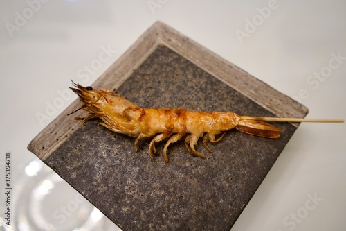 Fried prawn with bamboo skewer at Japanese restaurant. photo