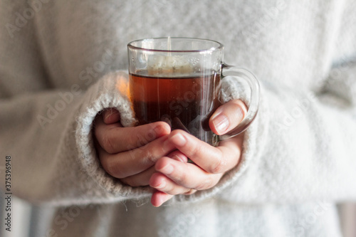 Woman holding a cup of hot tea photo