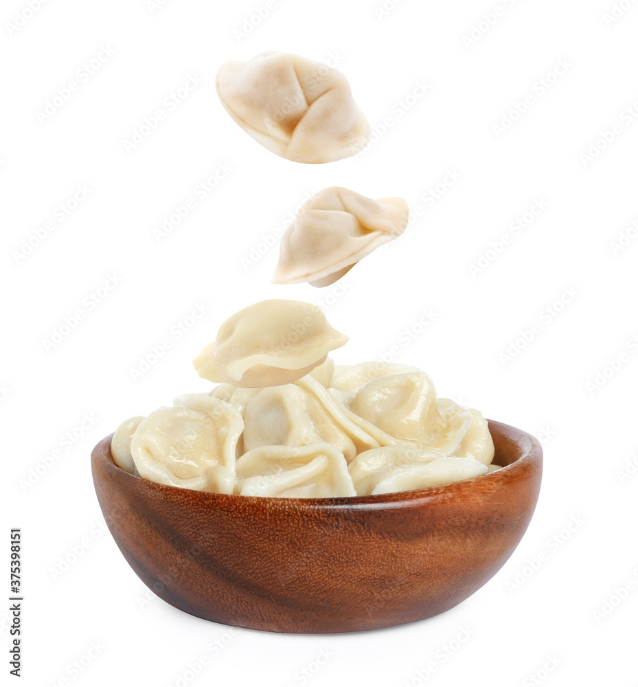Many tasty dumplings falling into bowl on white background Many tasty dumplings falling into bowl on white background