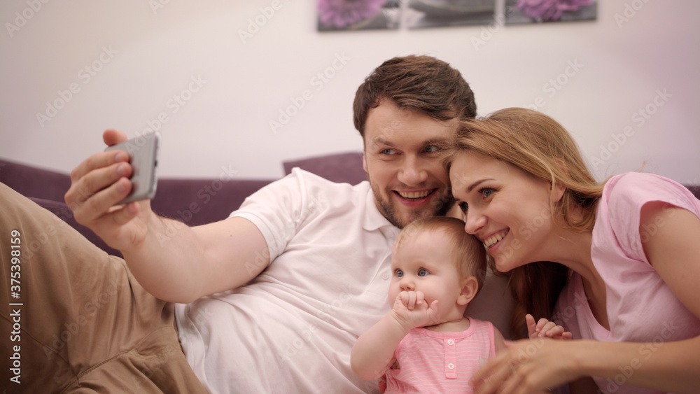 Selfie photo in family home. Man taking photo with happy family Selfie photo in family home. Man taking photo with happy family