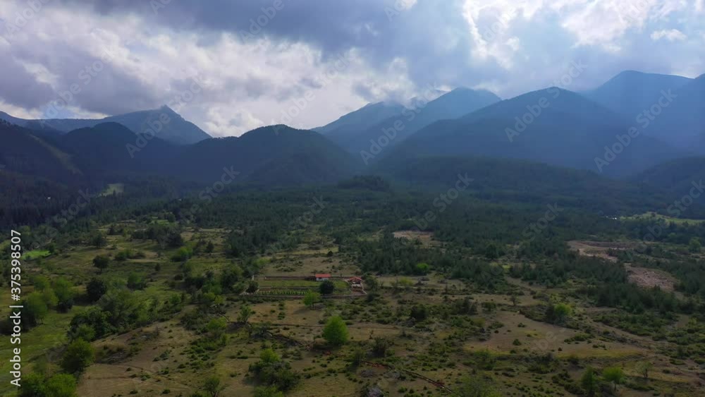 Mountains, clouds, summer time. Camera moves along the fields, small farm. Mountains, clouds, summer time. Camera moves along the fields, small farm.