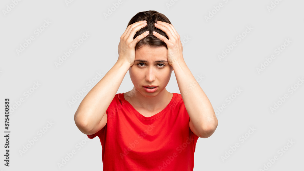 Feeling frustration. Exhausted woman portrait. Upset lady taking head in hands isolated on neutral copy space. Hopeless despair. Disappointment regret. Negative emotion Feeling frustration. Exhausted woman portrait. Upset lady taking head in hands isolated on neutral copy space. Hopeless despair. Disappointment regret. Negative emotion