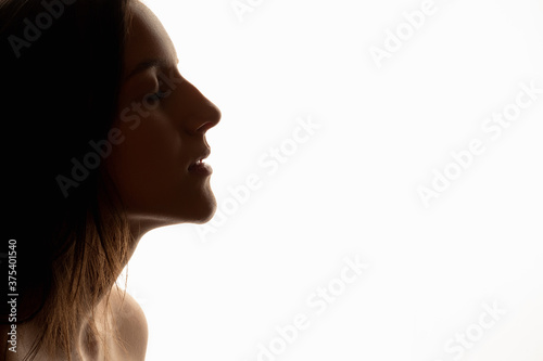 Female face silhouette. Natural beauty. Profile portrait of woman with clean skin closing eyes. Isolated on white copy space. Spa procedure. Body care. Green cosmetic