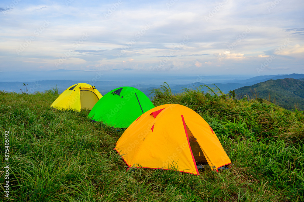 Trekking tents on green grass at Doi Suan Ya Luang, Ban San Charoen district, Nan province, Thailand