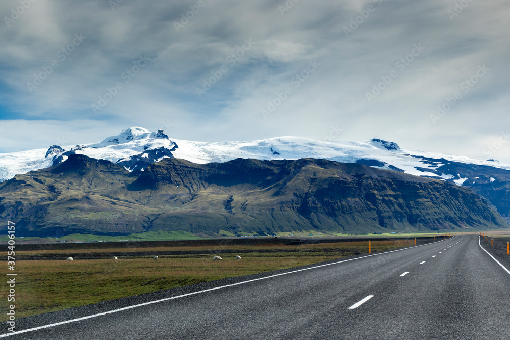 Fototapeta premium Road in Iceland with mountains and snow in the background
