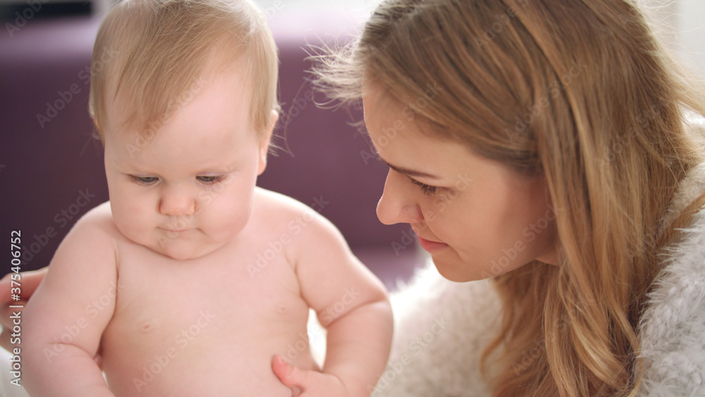 Mother playing with child. Naked baby girl learning play Mother playing with child. Naked baby girl learning play