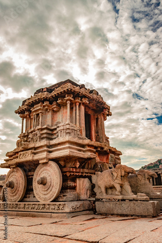 hampi stone chariot the antique stone art piece close up shot with amazing sky photo