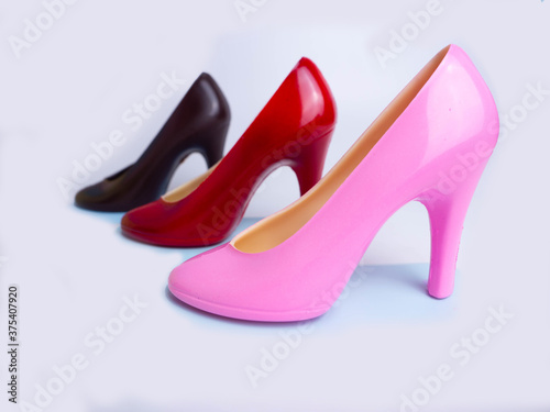 The shoes are made of dark chocolate on white background