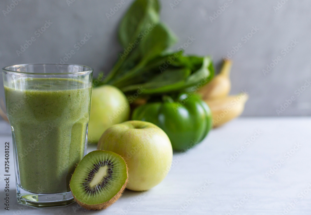 Healthy fresh natural green smoothie in glass. Made from spinach, apple, kiwi, avocado, bananas. Detox day. Healthy fresh natural green smoothie in glass. Made from spinach, apple, kiwi, avocado, bananas. Detox day.