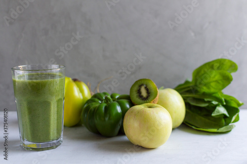 Healthy fresh natural green smoothie in glass. Made from spinach, apple, kiwi, sweet pepper. Detox