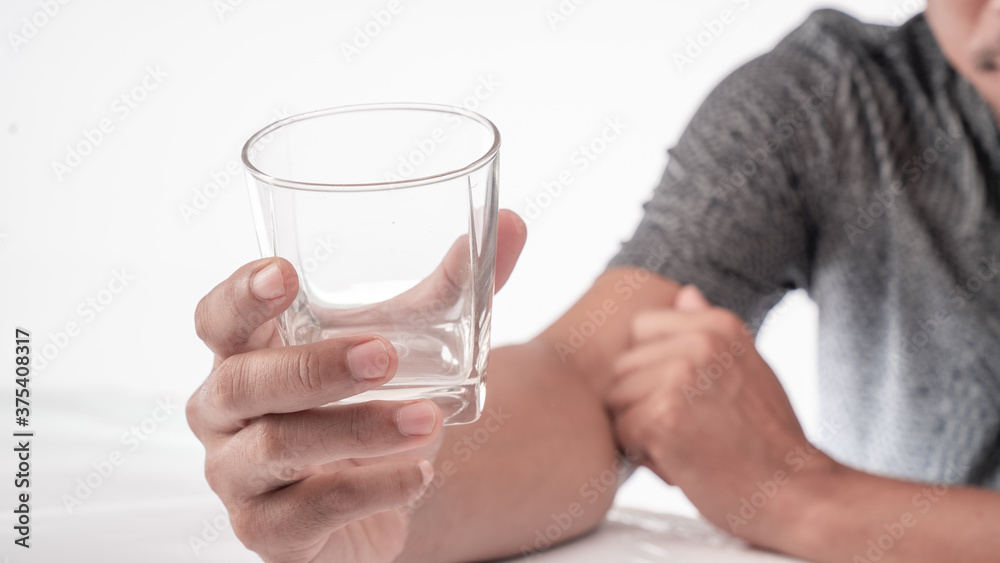 man holding a glass of water in his hand man holding a glass of water in his hand