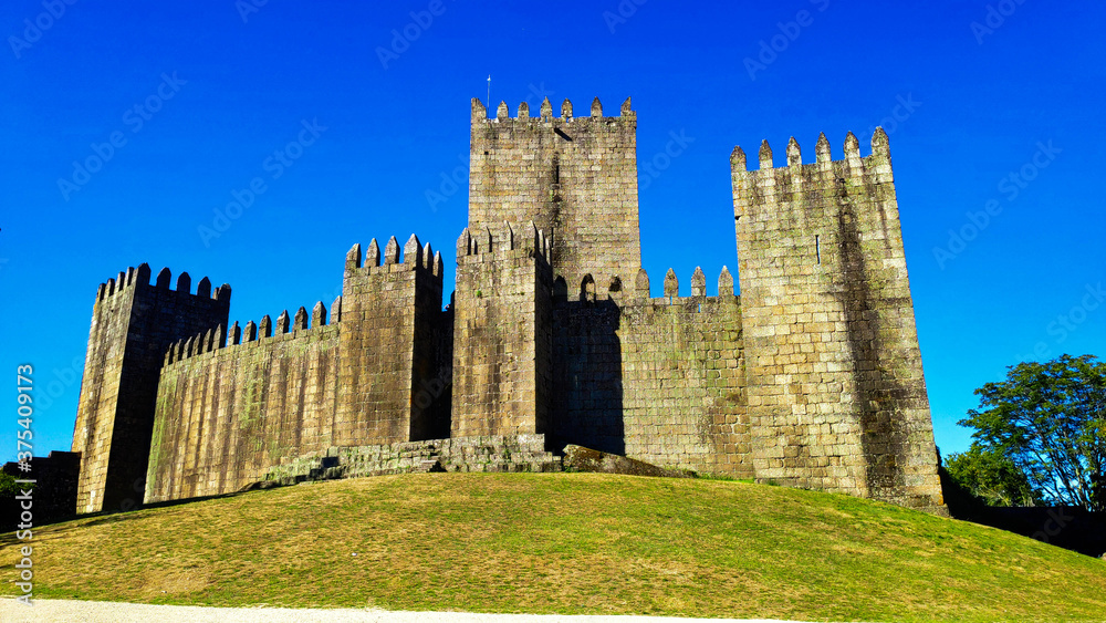 Guimarães Castle with a sunny day in season summer. Portugal.