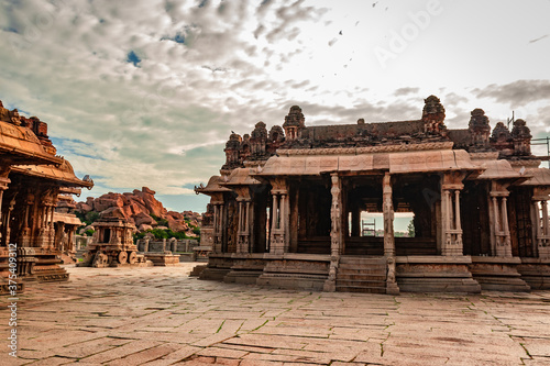 vithala temple hampi ruins antique stone art from unique angle with amazing blue sky photo