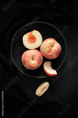 Peaches in a dark bowl