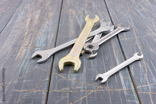 Wrenches on wooden background