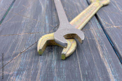 Wrenches on wooden background, macro