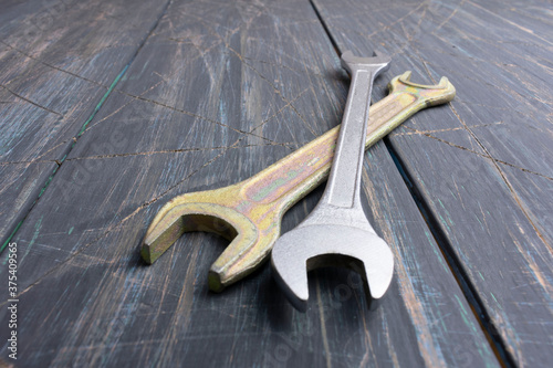 Wrenches on wooden background, macro