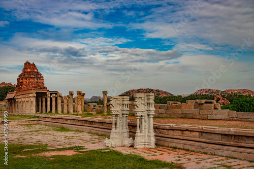 vithala temple hampi ruins antique stone art from unique angle with amazing blue sky photo