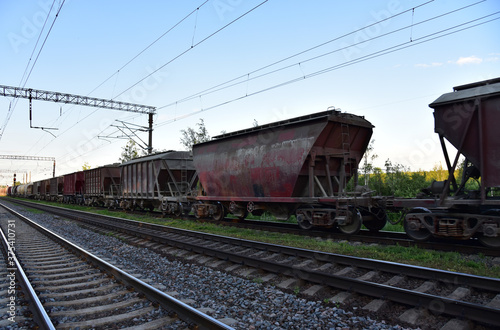 Hopper wagons and rail road cars for transportation of cement, ready-mix and building materials. Shipping by rail from the concrete factory. Freight cars, hopper car for sand or mineral products