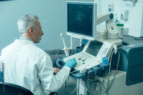 Ultrasound scanner in the modern clinic and doctor working