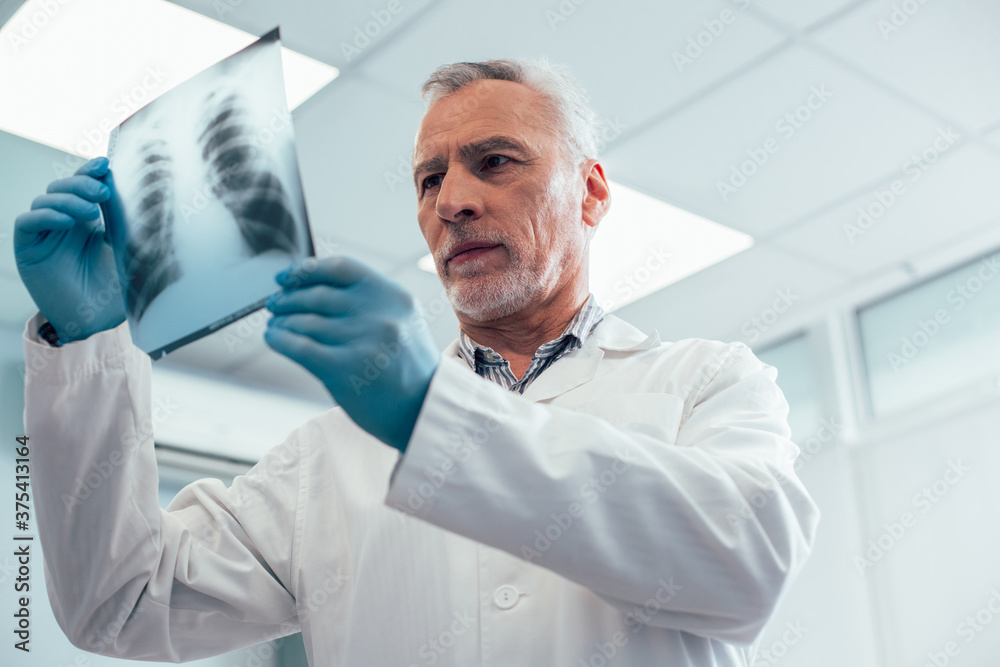 Professional therapist interpreting chest x-ray in the clinic Professional therapist interpreting chest x-ray in the clinic