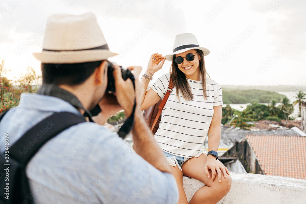 Happy tourist couple taking pictures. Travel and love concept in Latin America